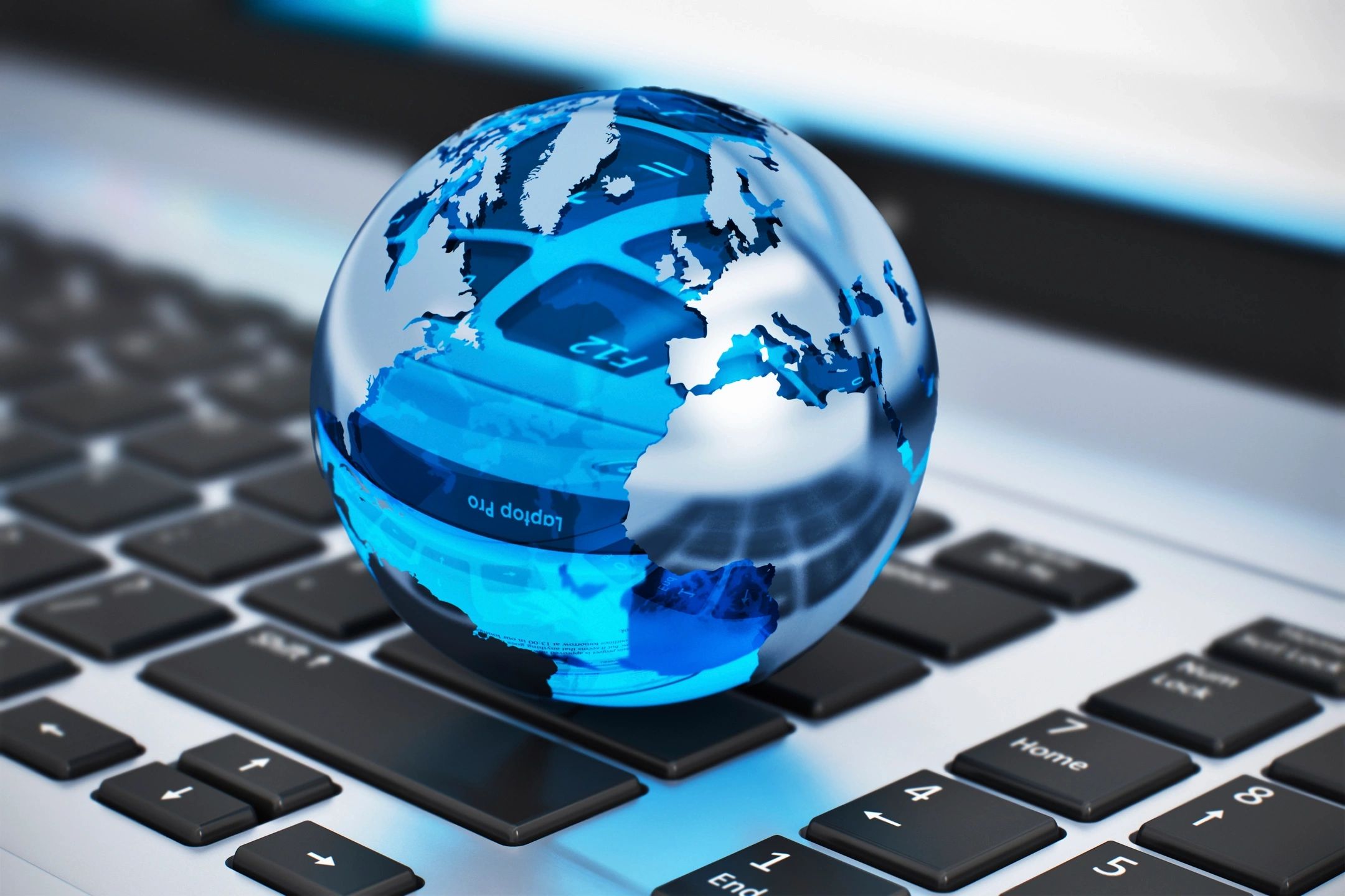 glass globe above a laptop keyboard